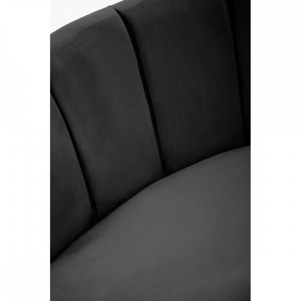 Close-up of black velvet sofa upholstery and curved padded backrest