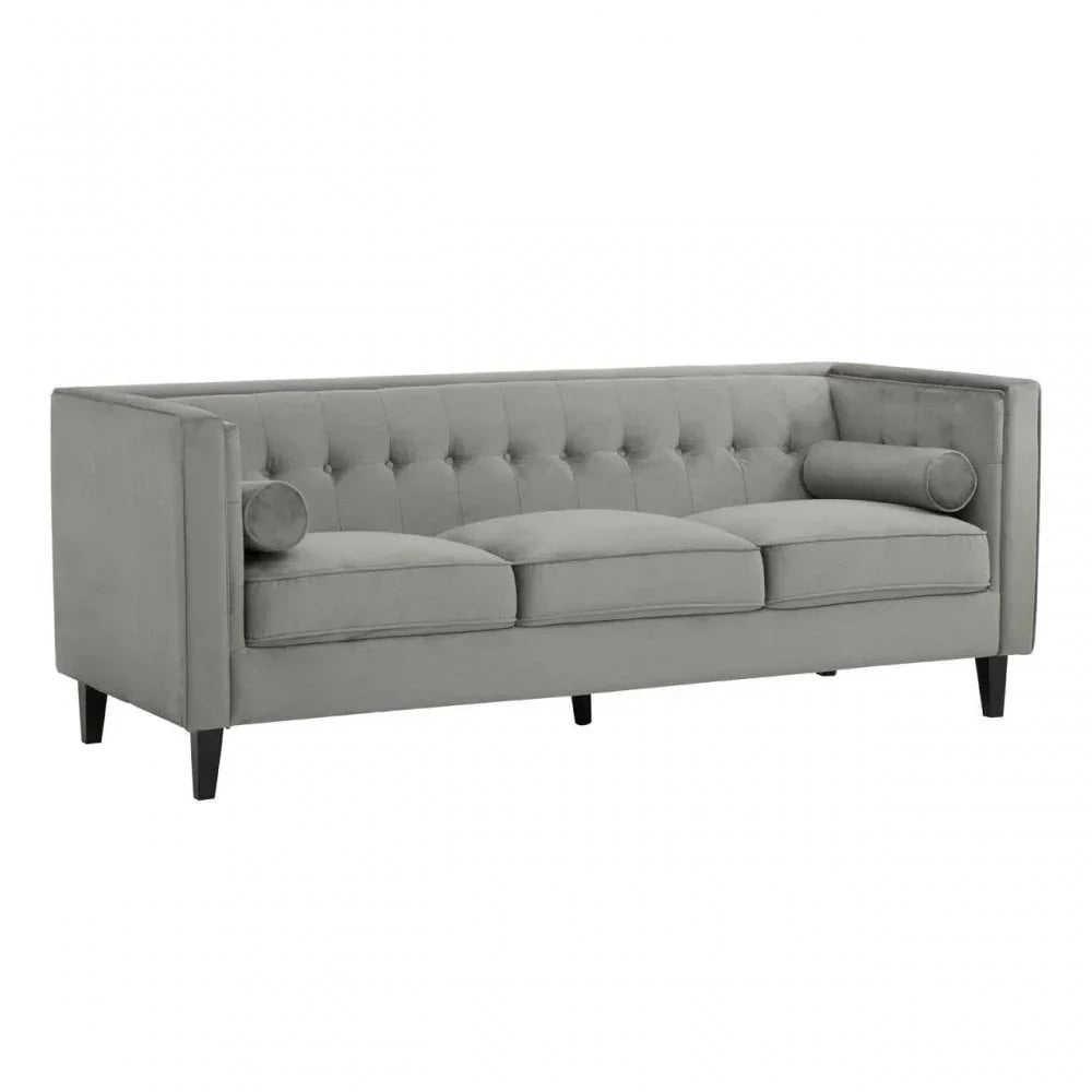 Grey velvet three seater sofa with tufted back and bolster cushions on wooden legs