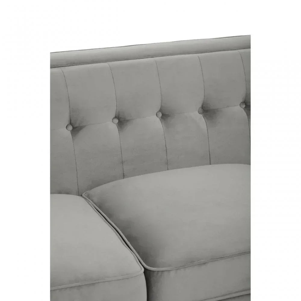 Close-up of tufted grey sofa upholstery and seat cushions