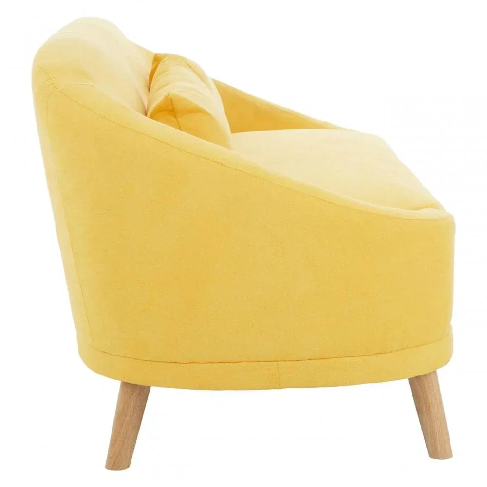 Side view of yellow fabric accent chair with wooden legs