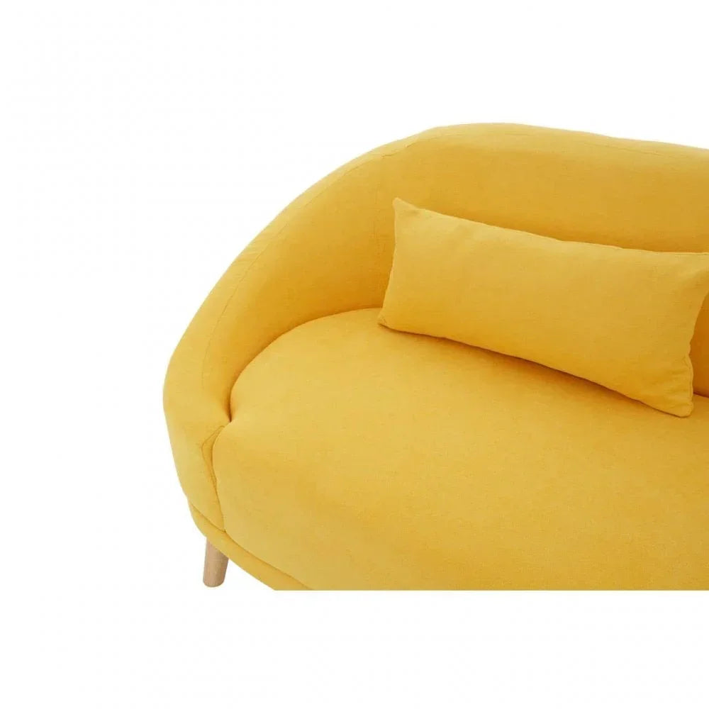 Curved yellow fabric sofa with matching cushion and wooden legs, close-up view