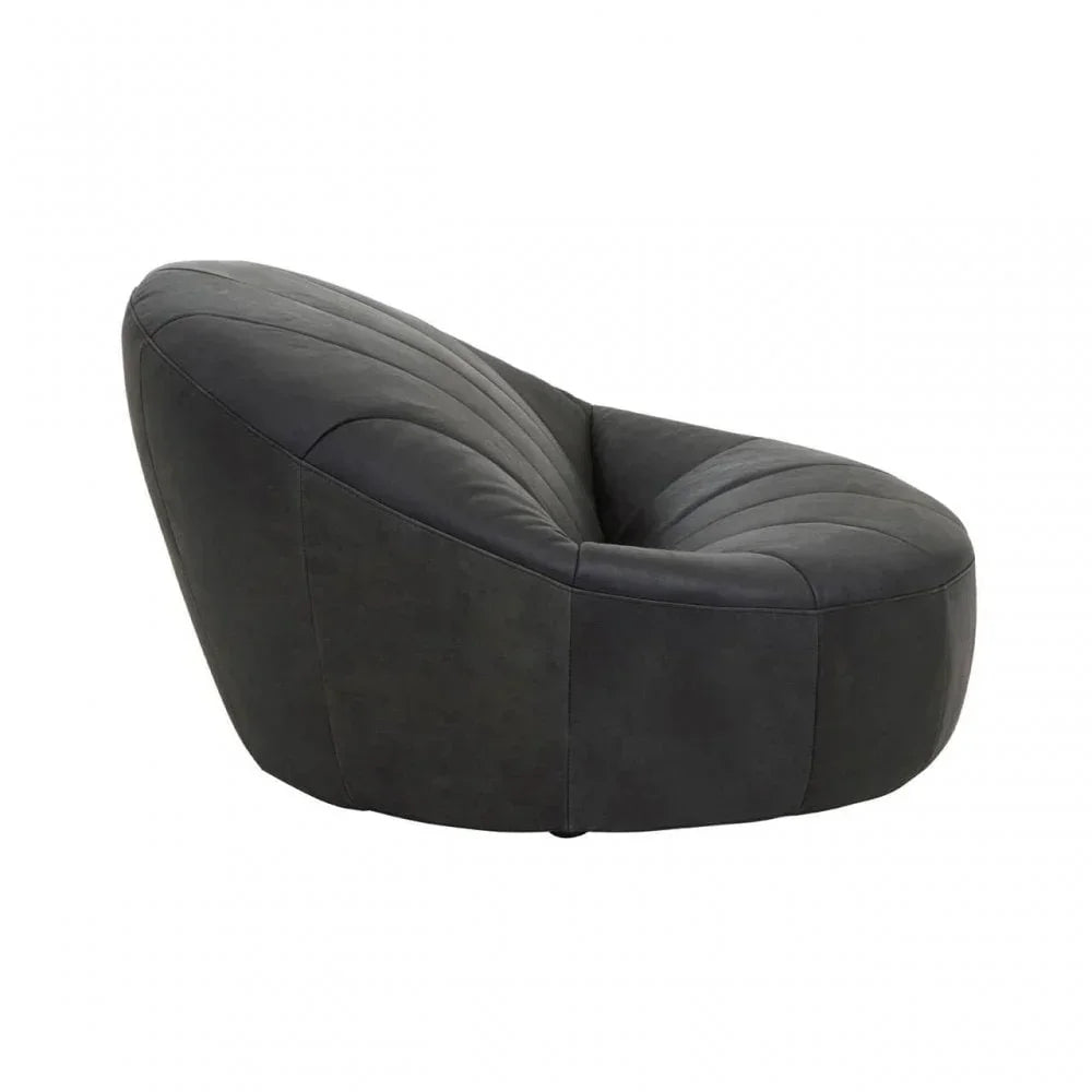Curved black accent chair with soft upholstery and modern stitched detailing