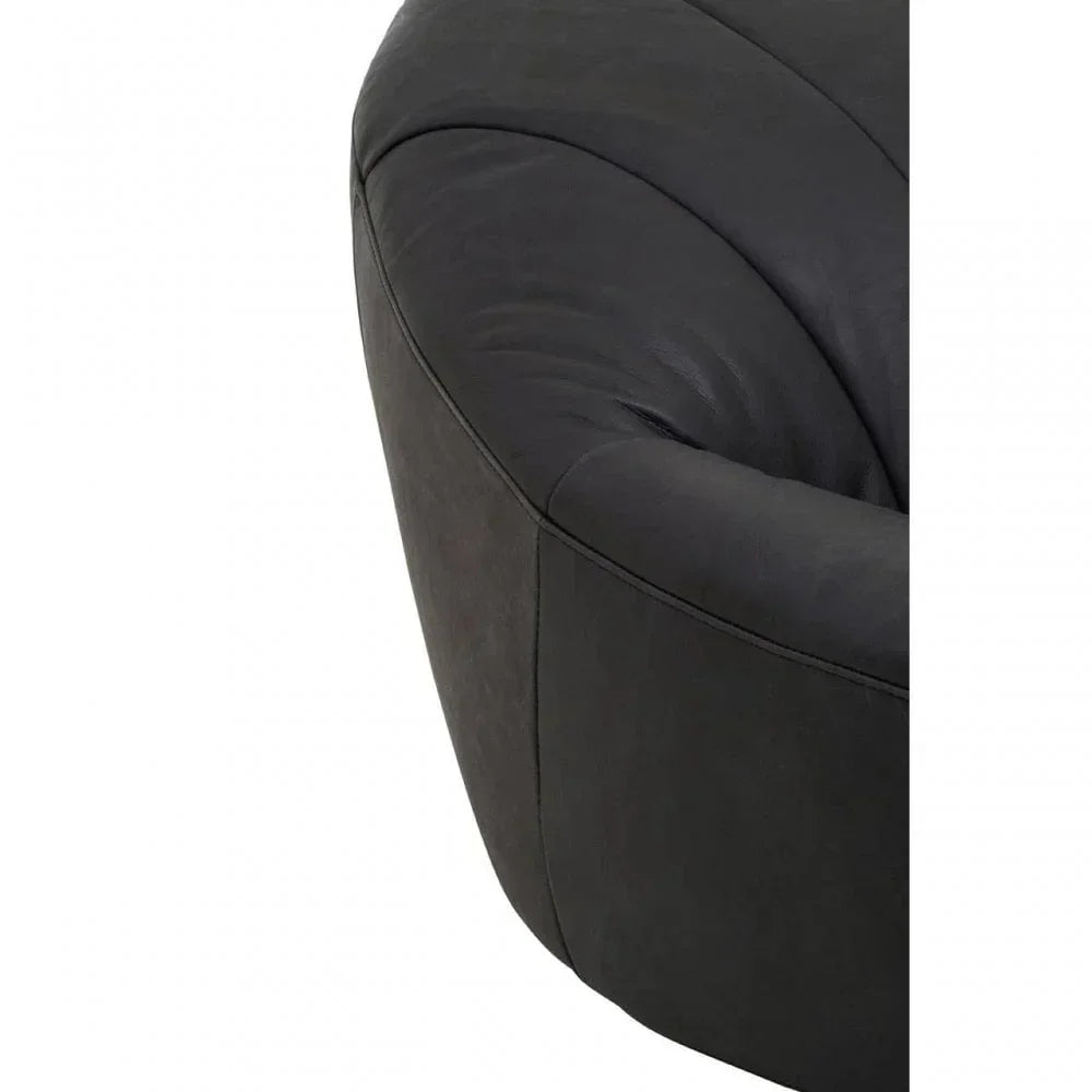 Close-up of black leather sofa armrest with curved stitching detail