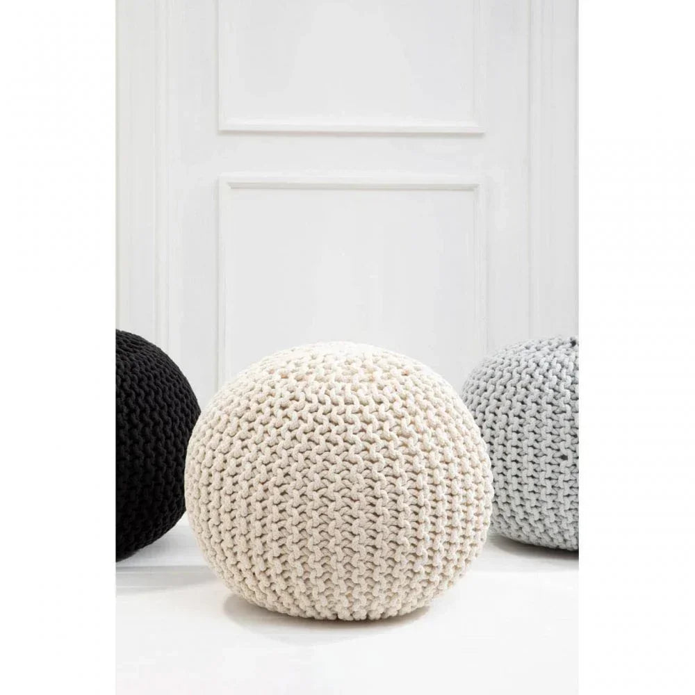 Cream knitted pouffe with chunky texture in modern living room setting