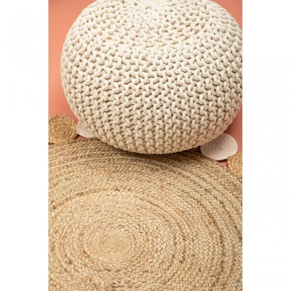 Round jute rug and cream knitted pouffe on a terracotta background