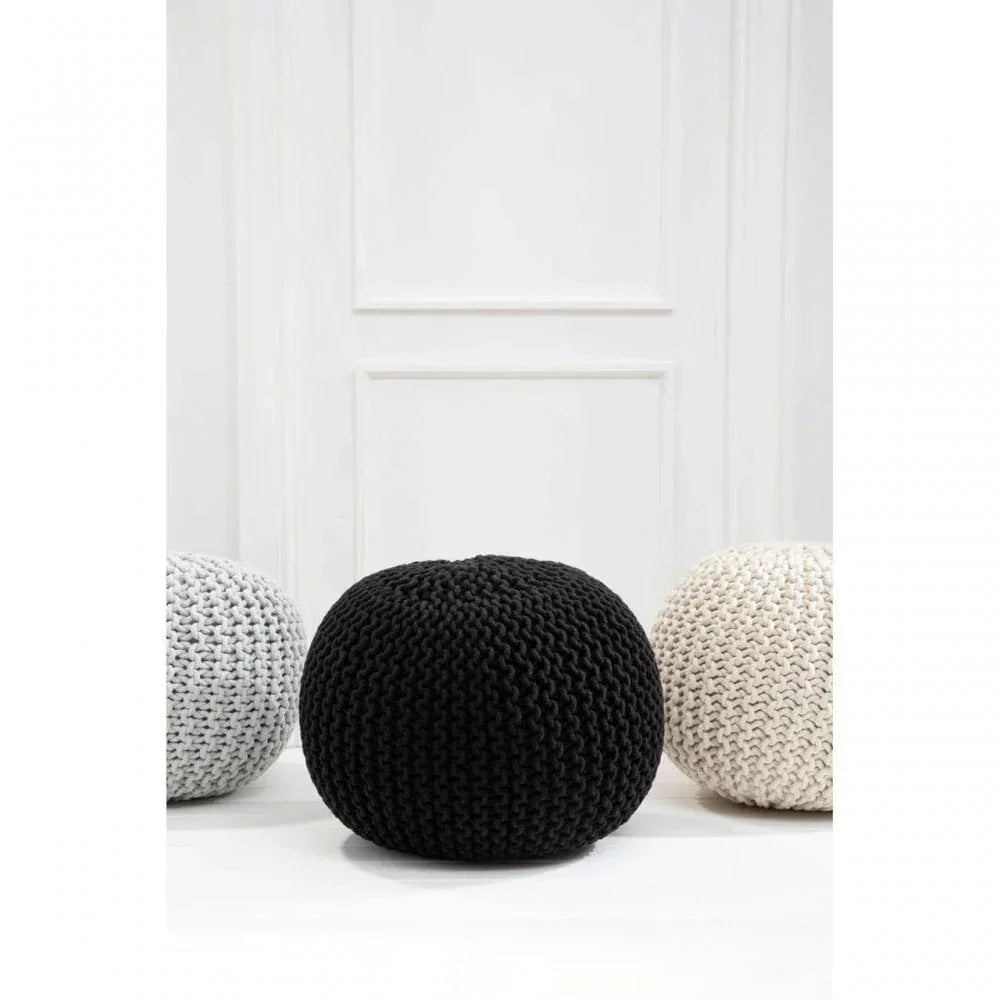 Black knitted pouffe ottoman with chunky weave, styled with grey and cream pouffes