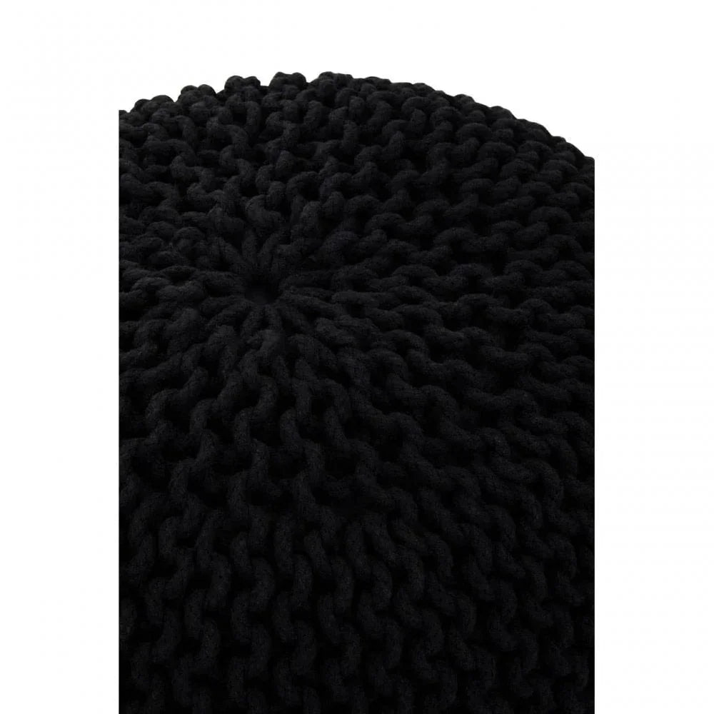 Close up of black knitted pouffe showing chunky textured yarn pattern