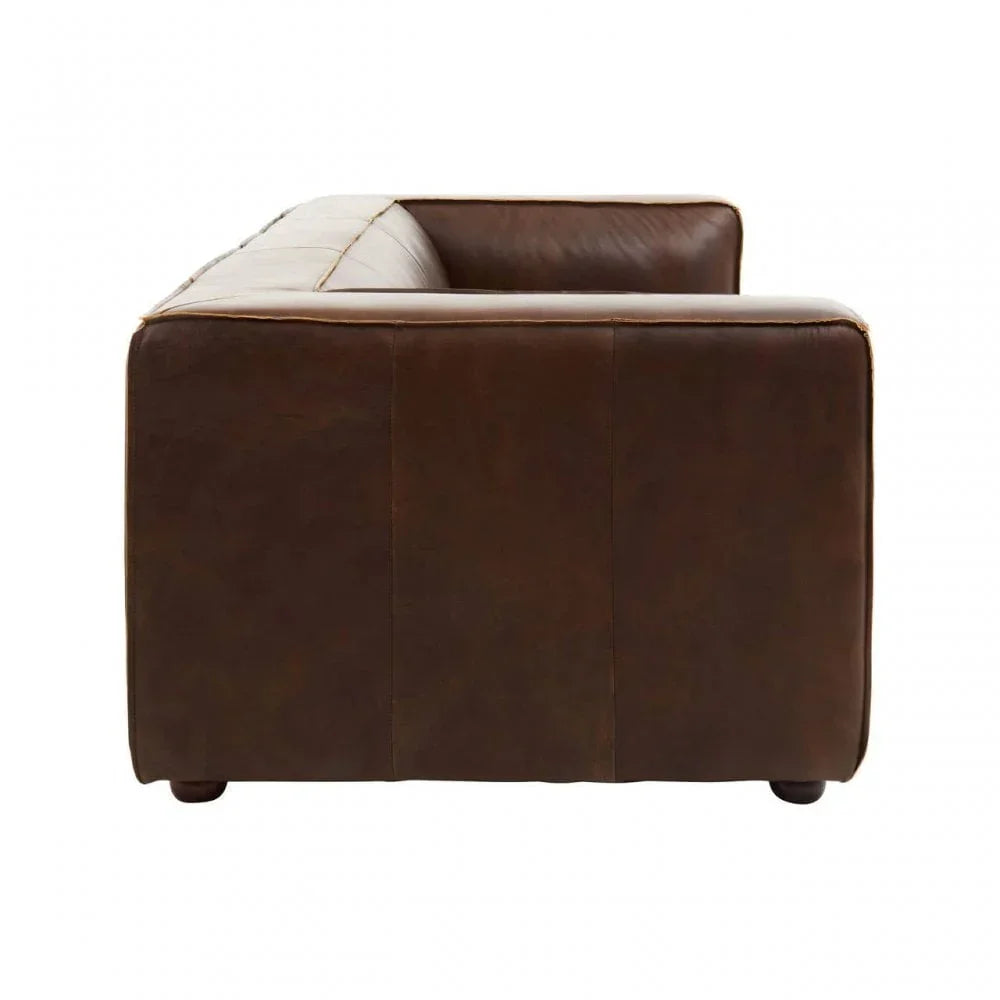 Side view of a brown leather sofa with square armrest and clean lines