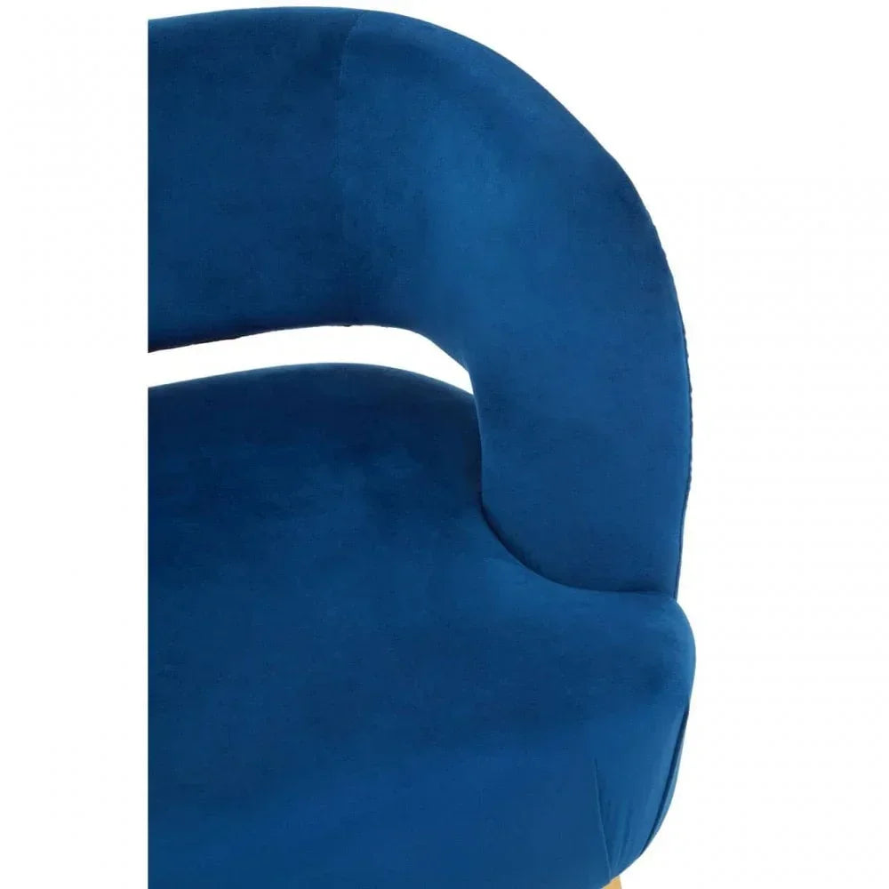 Curved velvet accent chair in royal blue with soft upholstery and modern armrest detail
