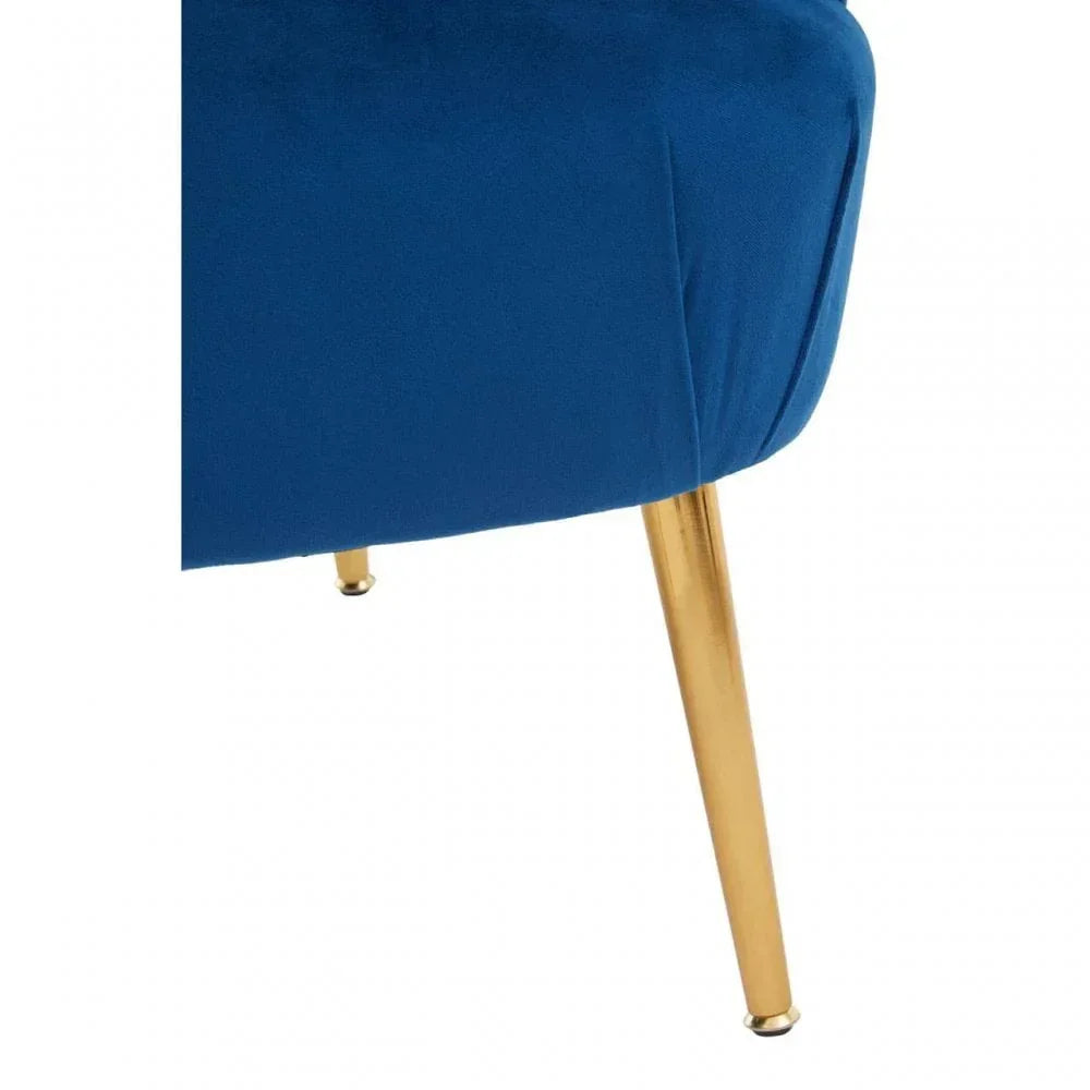 Blue velvet chair with gold metal legs, close-up of upholstery and leg detail