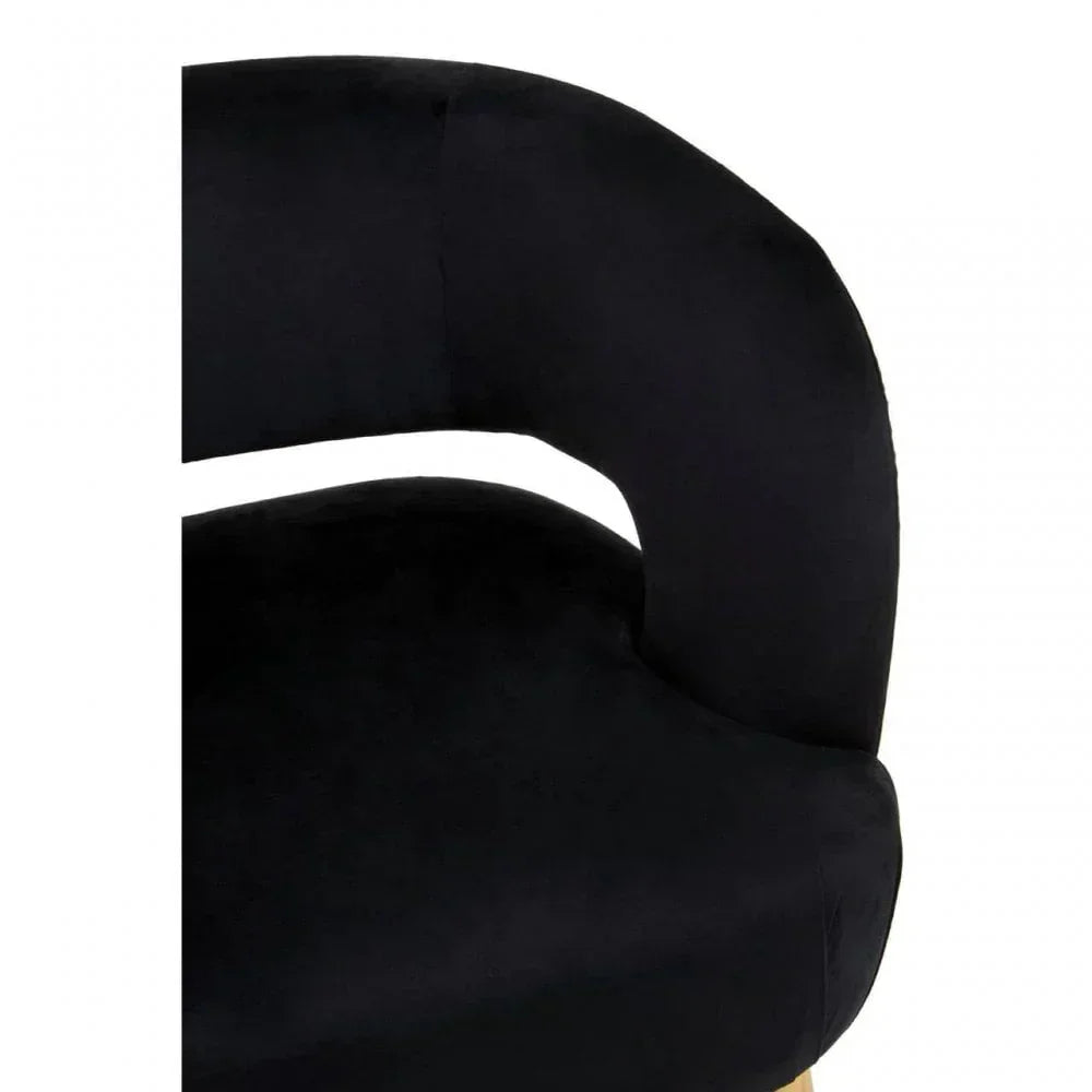 Close-up of black velvet accent chair with curved backrest and padded seat