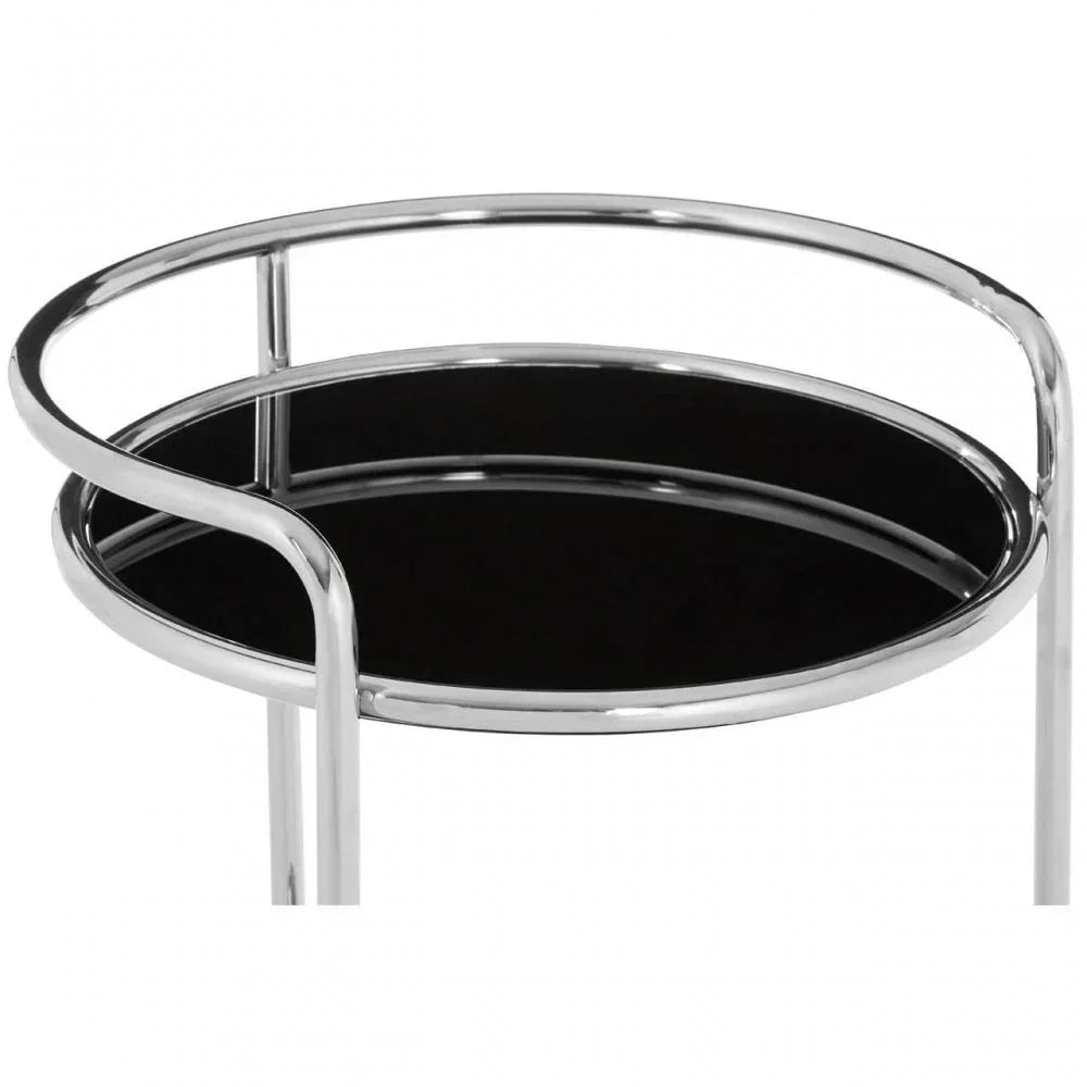 Round side table with black glass top and chrome frame, close-up of upper section