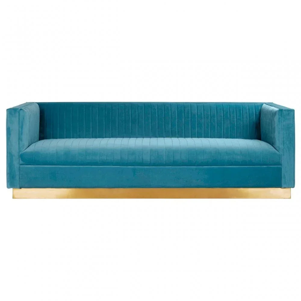 Blue velvet sofa with gold base, straight armrests and vertical stitching, front view