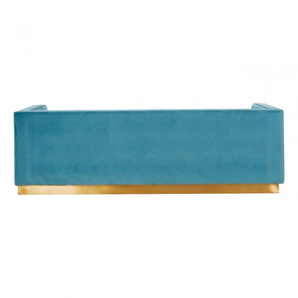 Blue velvet sofa back view with gold base trim
