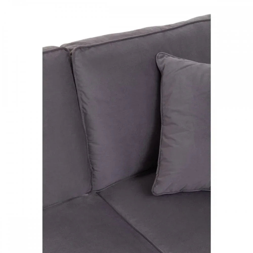 Closeup of dark grey fabric sofa cushion and seat with matching throw pillow