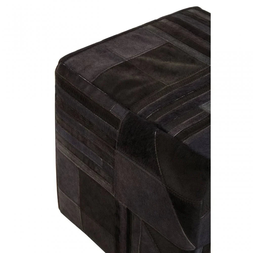 Black patchwork leather ottoman close-up showing texture and stitching detail