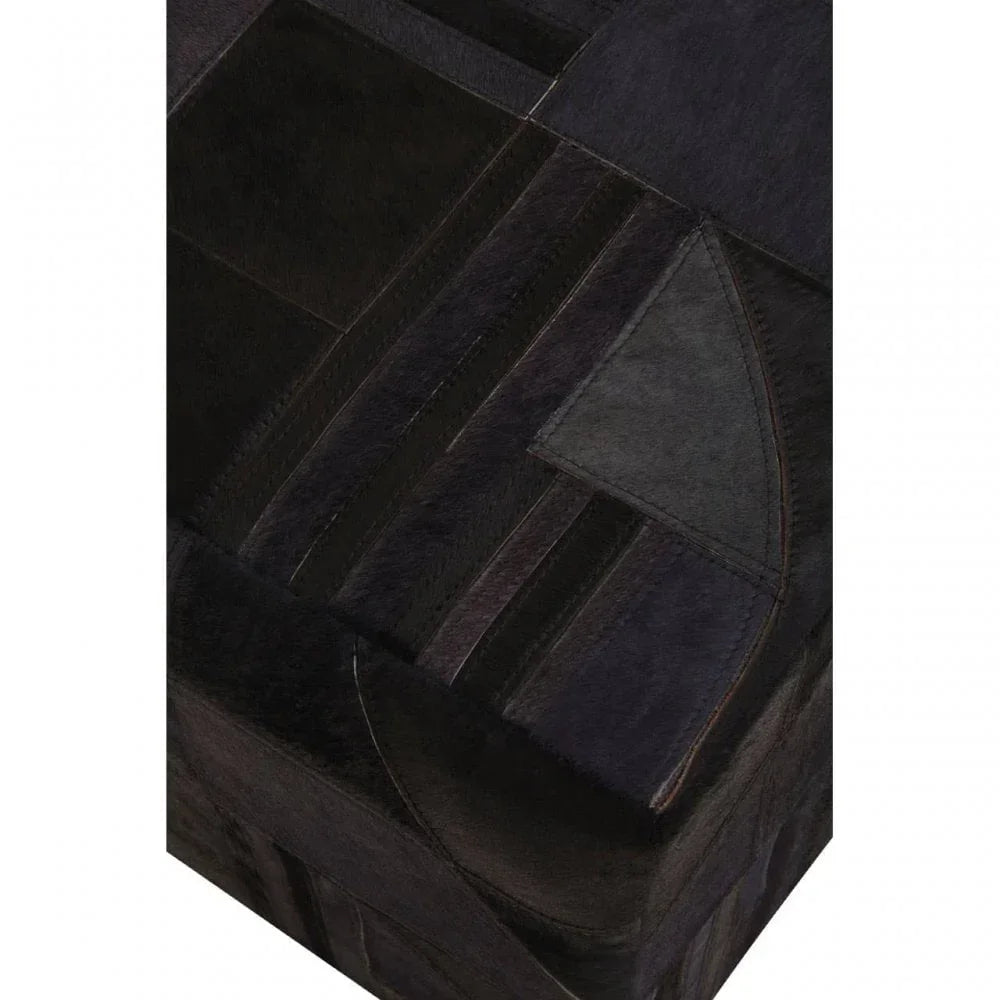 Closeup of black leather pouffe with stitched patchwork detail