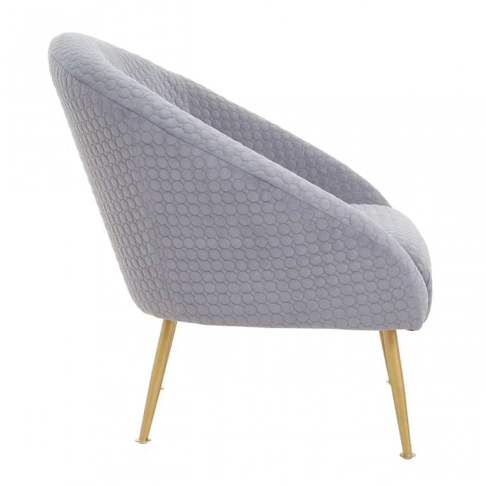 Grey accent chair with textured upholstery and gold metal legs, side profile view