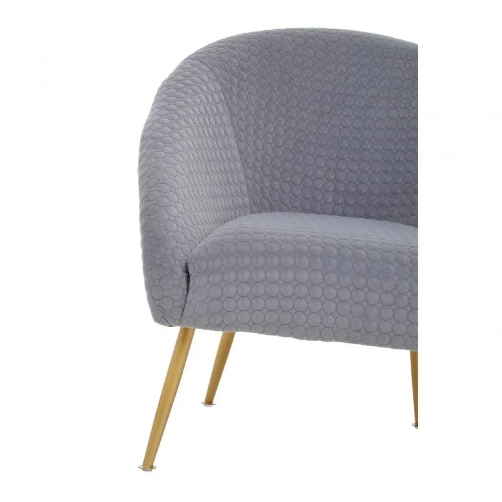 Grey accent chair with textured circle upholstery and angled gold metal legs