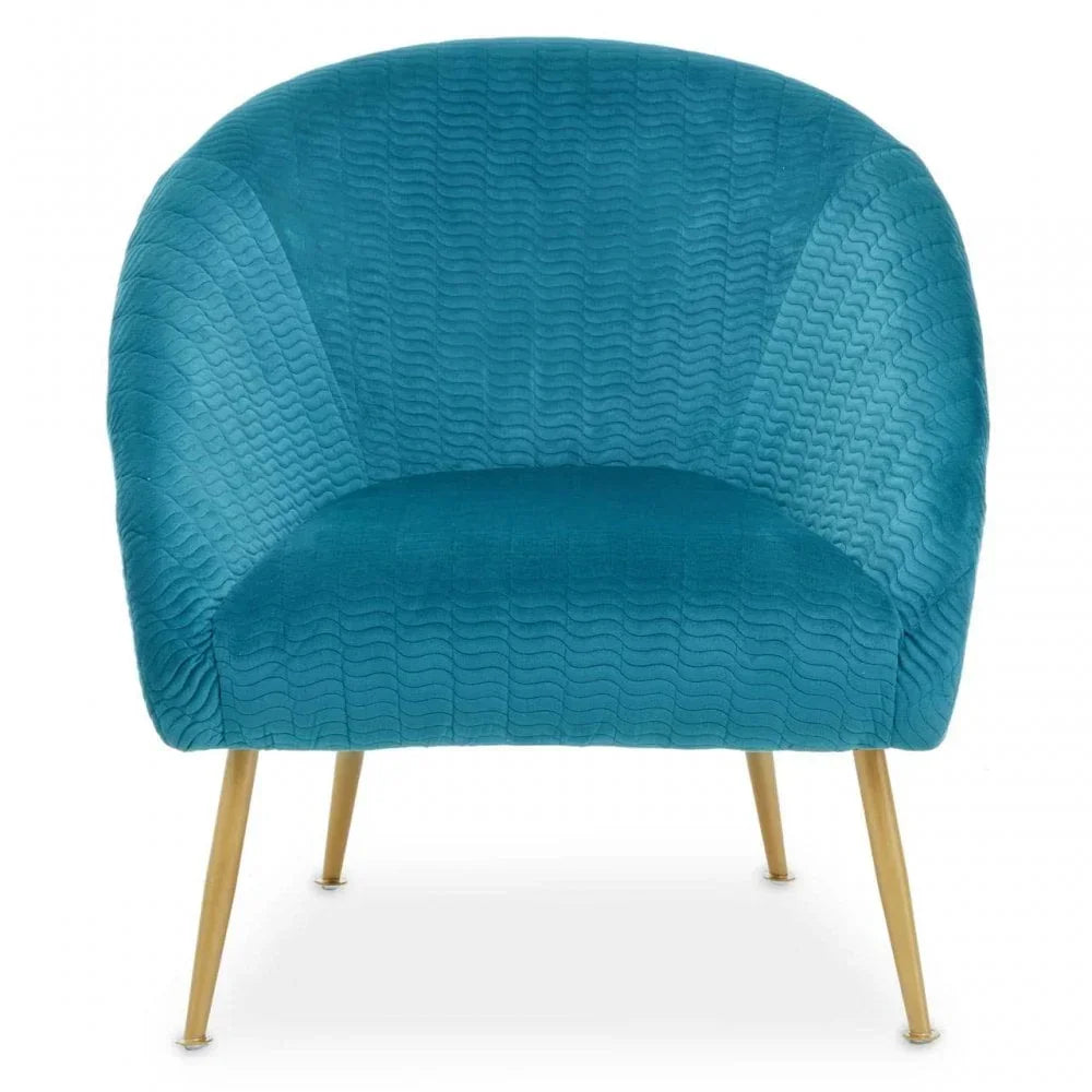 Blue velvet armchair with curved backrest and gold metal legs, front view
