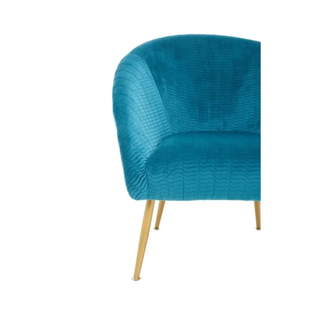 Blue velvet accent chair with gold legs and textured upholstery, front side view