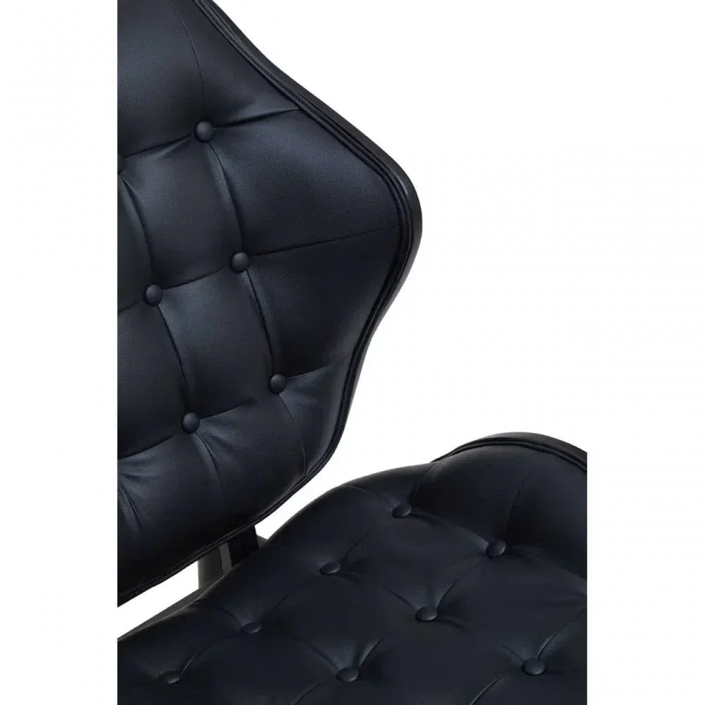 Black leather accent chair with button tufted backrest and seat close up