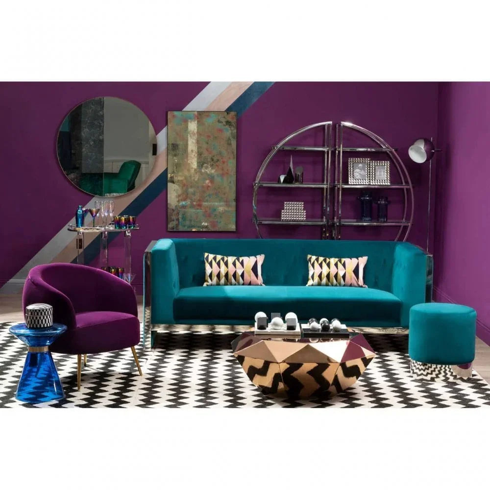 Teal velvet sofa with patterned cushions in modern living room with geometric coffee table