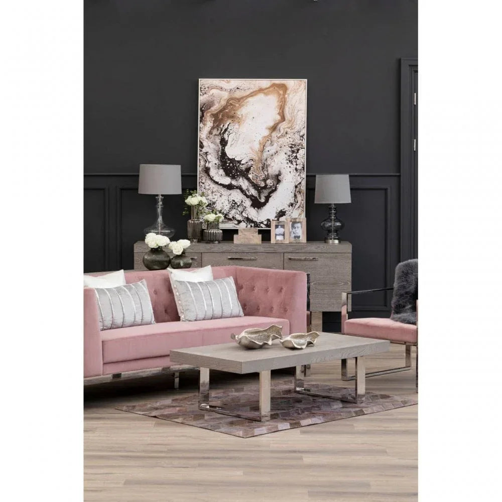 Contemporary living room with pink velvet sofa, modern coffee table, and abstract wall art