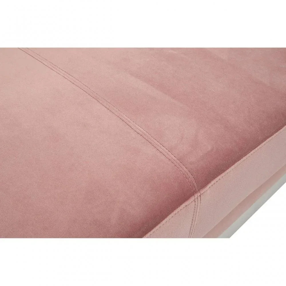 Close-up of pink upholstered bed frame corner with stitched seam detail