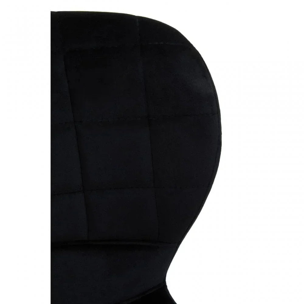 Close-up of black velvet chair backrest with grid stitch detailing