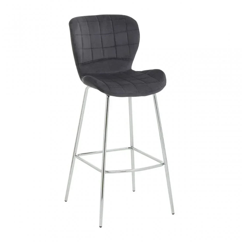 Grey velvet bar stool with chrome legs and quilted backrest, angled front view