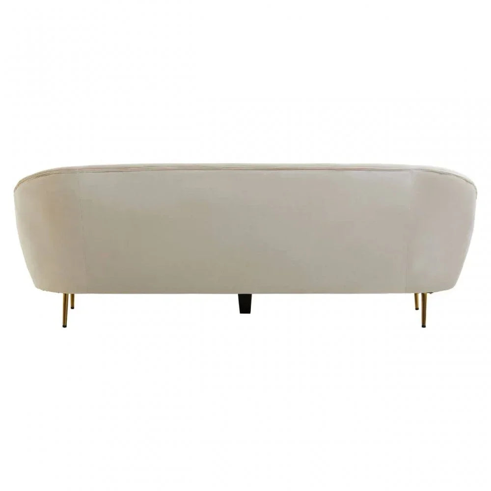 Rear view of cream upholstered sofa with slim gold legs
