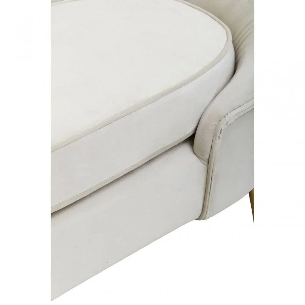 Closeup of cream fabric sofa cushion and armrest with piping detail