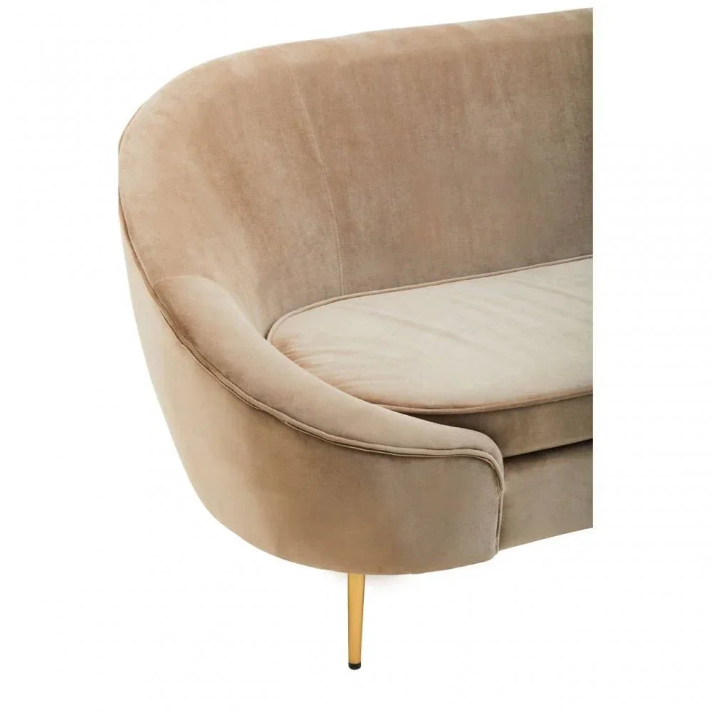 Curved beige velvet sofa with slim gold metal leg, close-up on armrest and seat