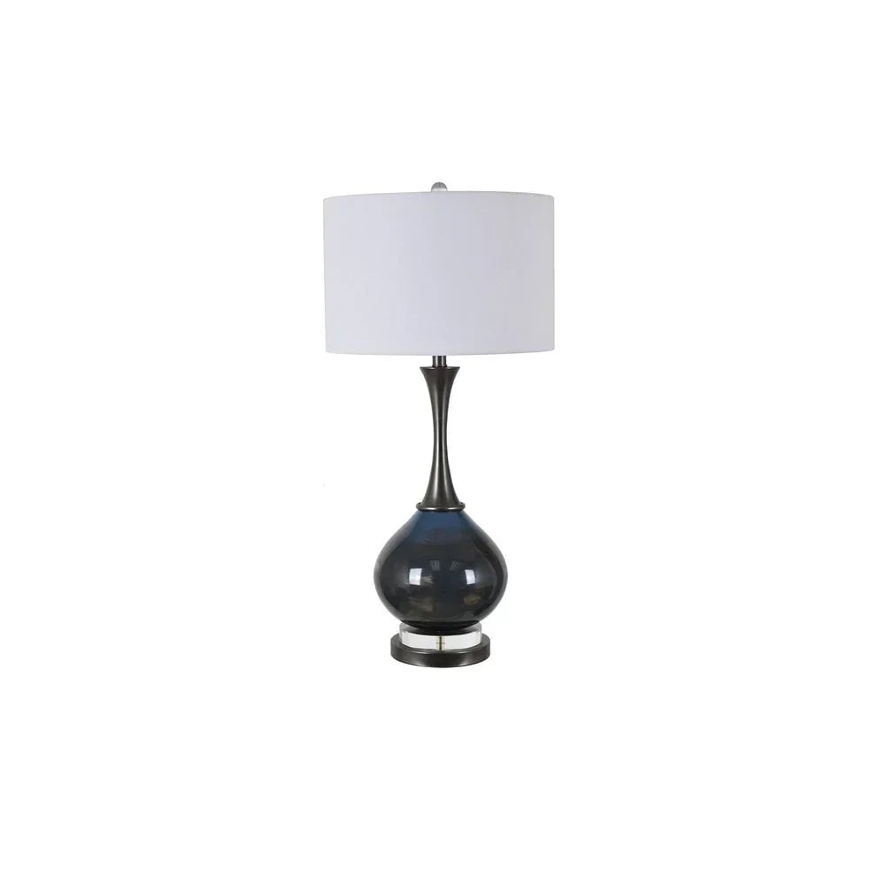 Blue glass table lamp with rounded base and white drum shade