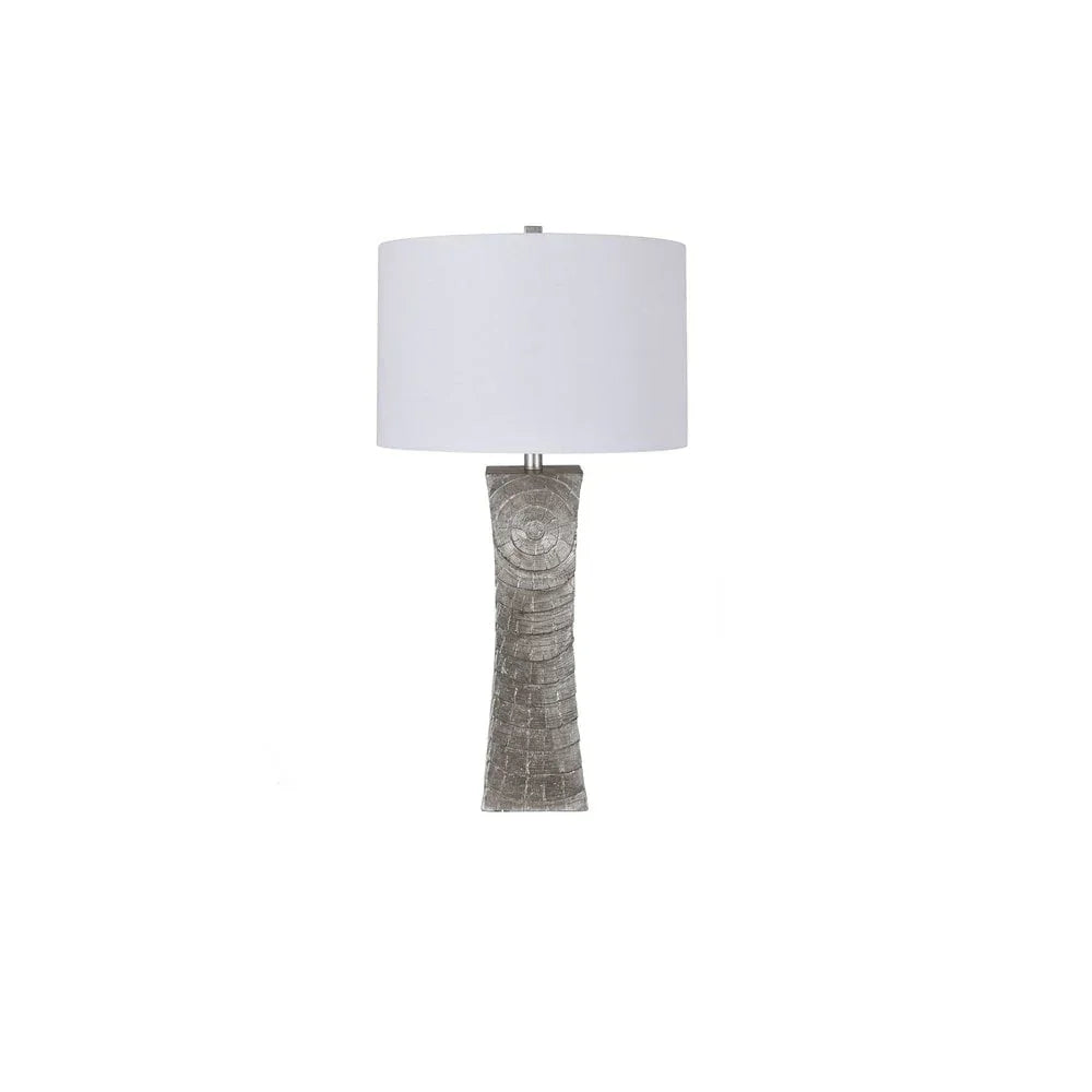 Silver textured table lamp with circular pattern base and white drum lampshade