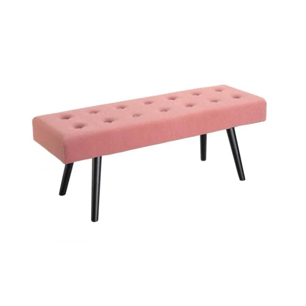 Pink upholstered bench with button tufting and black angled wooden legs