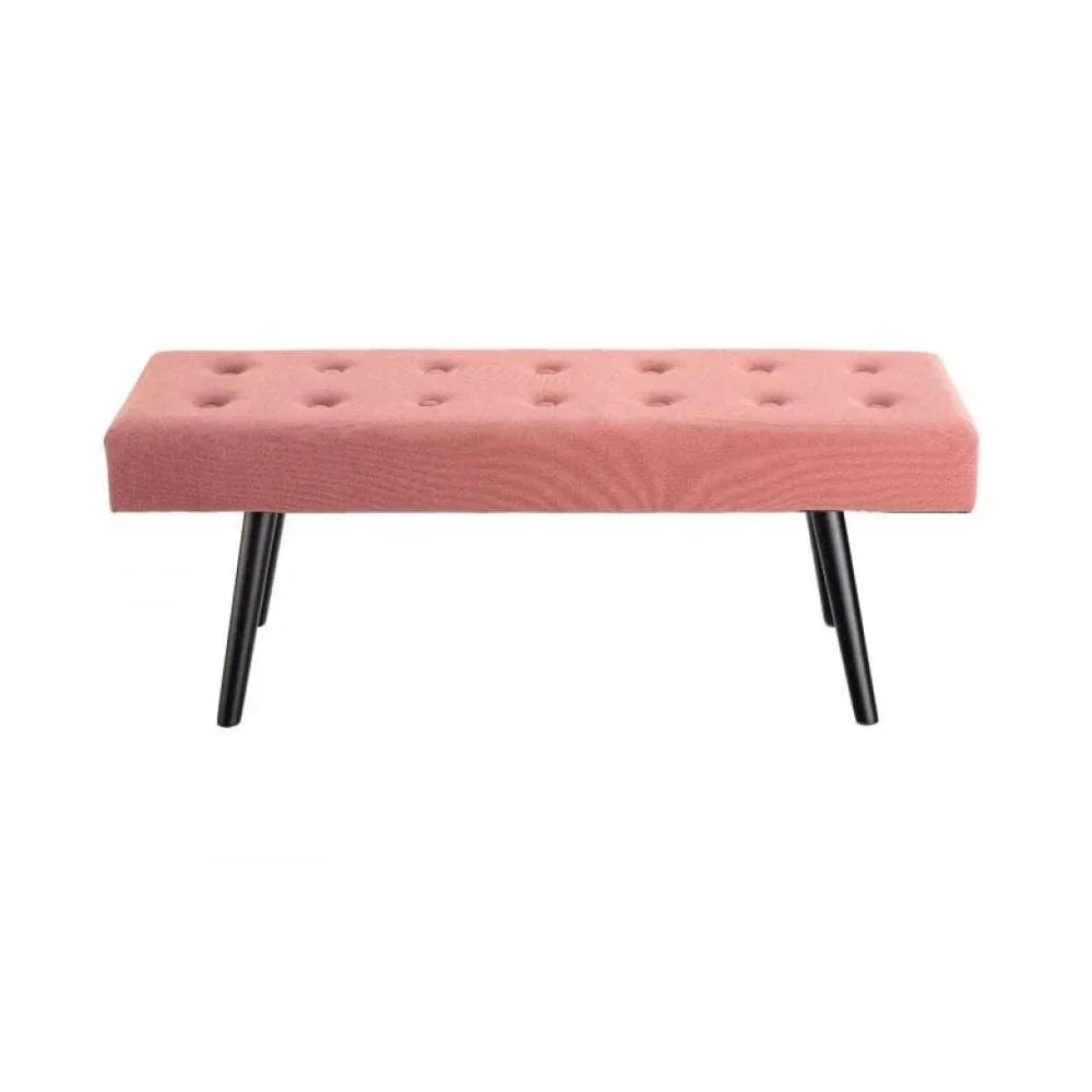 Pink upholstered bench with black angled legs and button-tufted seat on white background