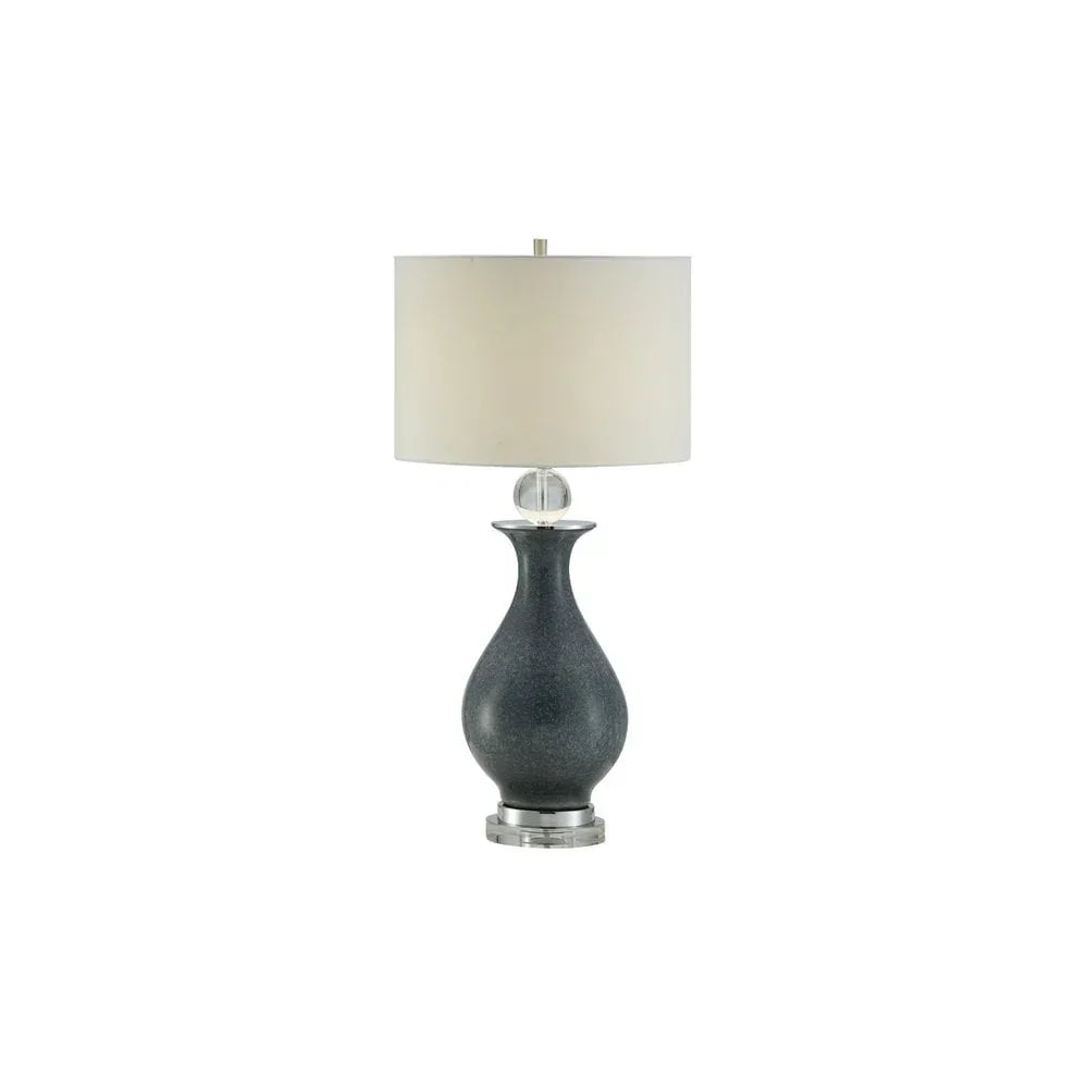 Ceramic table lamp with dark grey base and white drum shade on chrome stand
