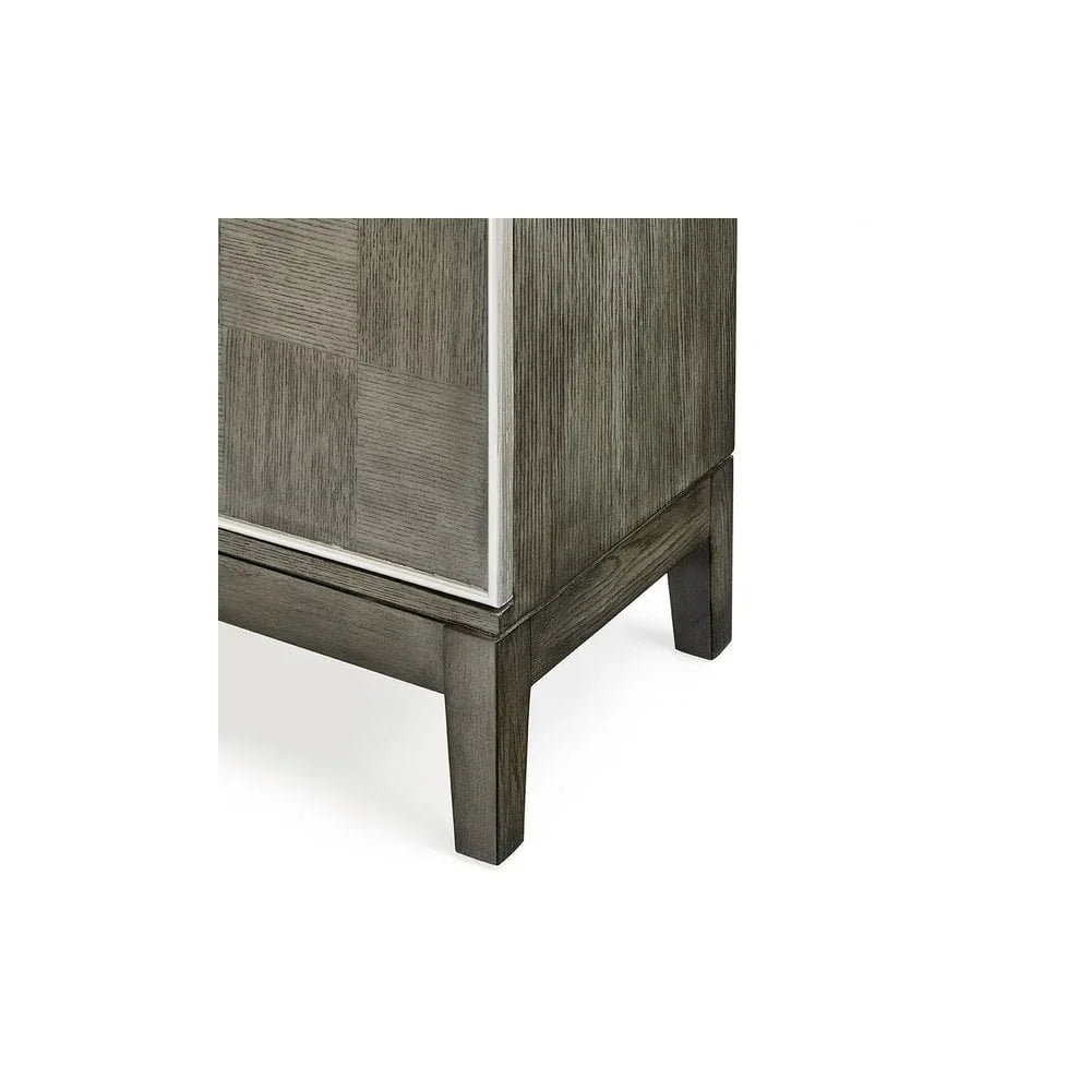 Close view of grey wooden cabinet leg and side panel with subtle grain texture