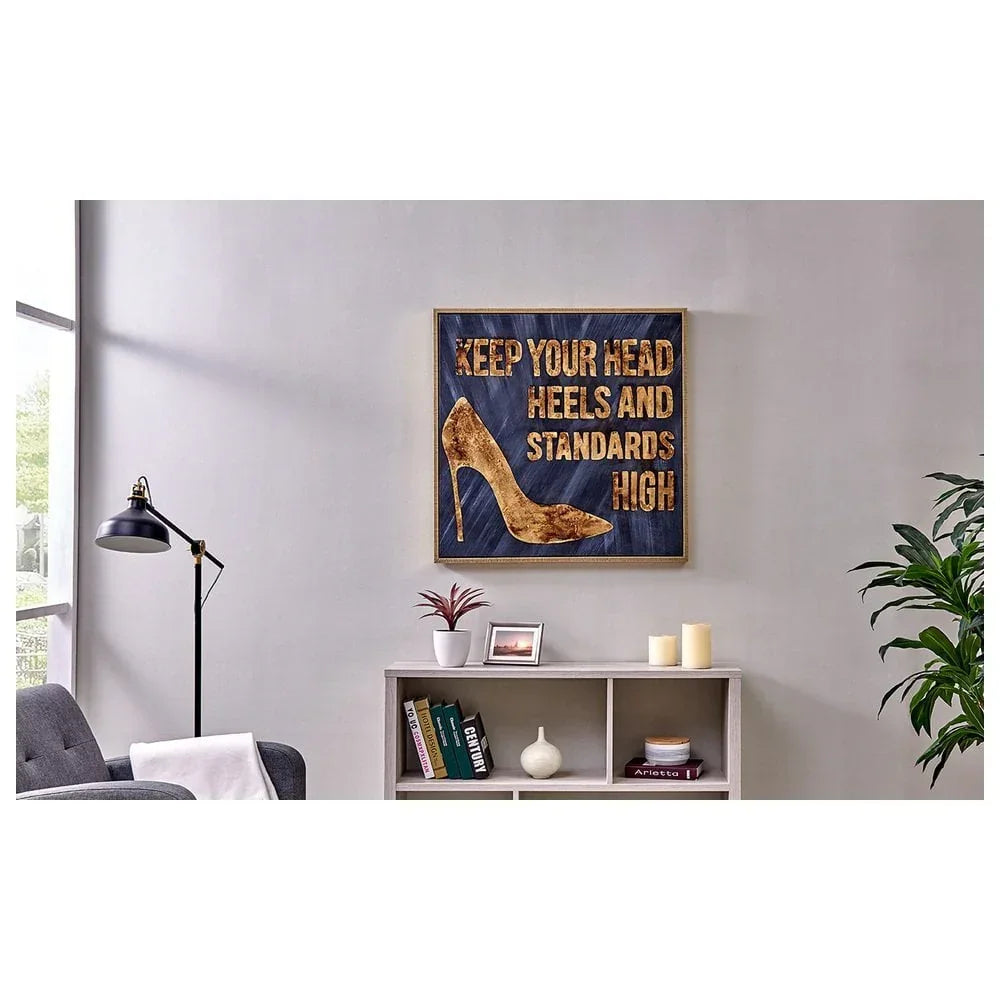Wall art with gold high heel and inspirational quote above modern living room shelf