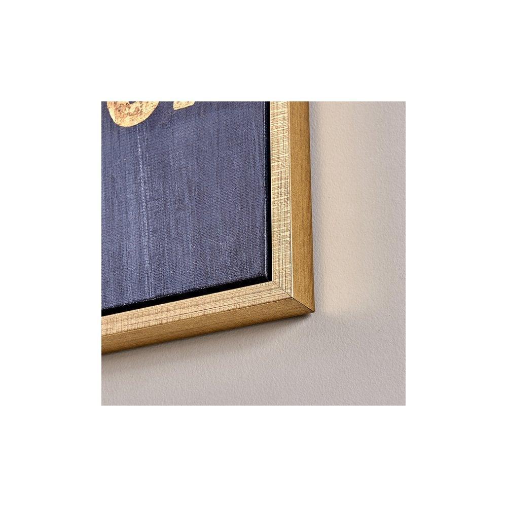 Gold wooden photo frame corner with dark blue canvas detail against light wall