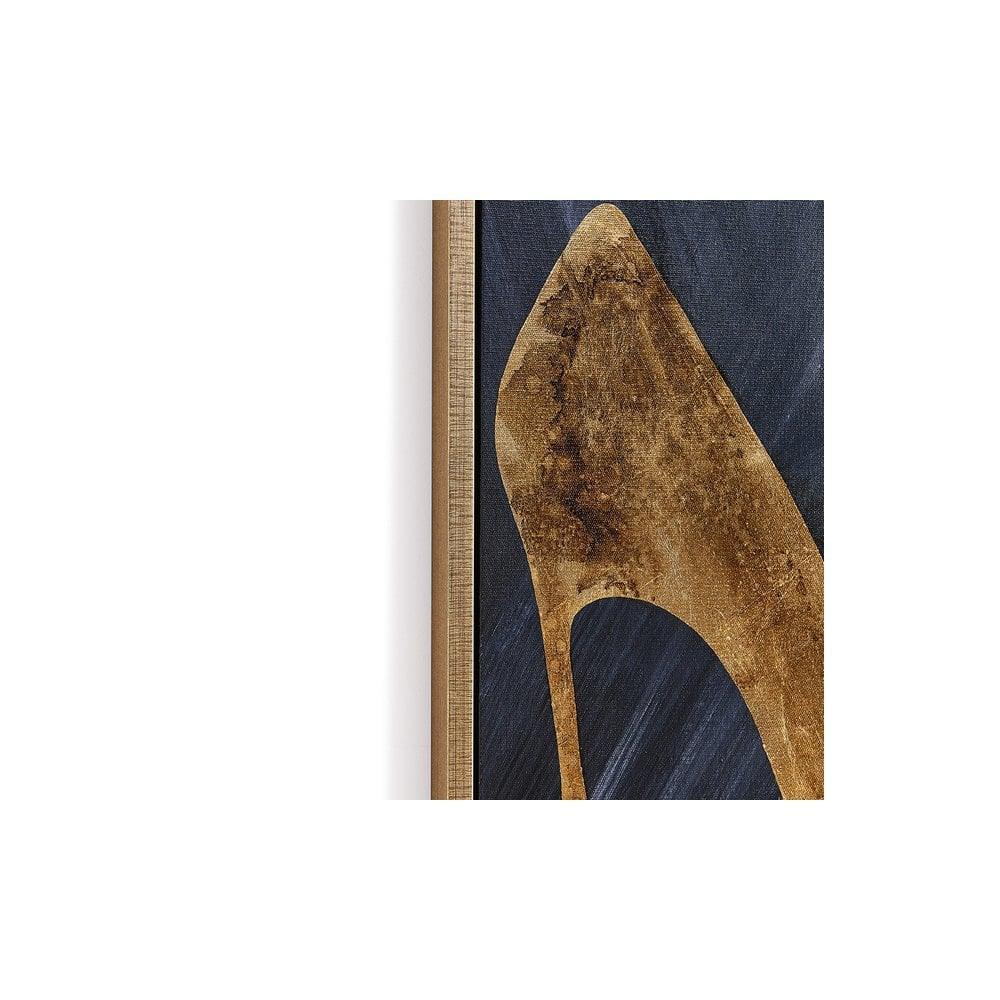 Framed gold stiletto high heel wall art on dark background, close up of canvas corner