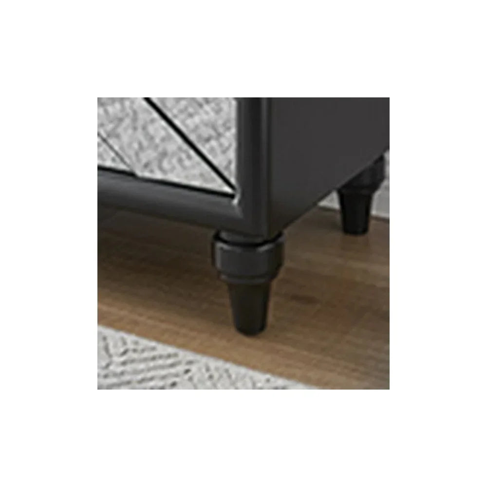 Black furniture leg detail on wooden floor with textured rug