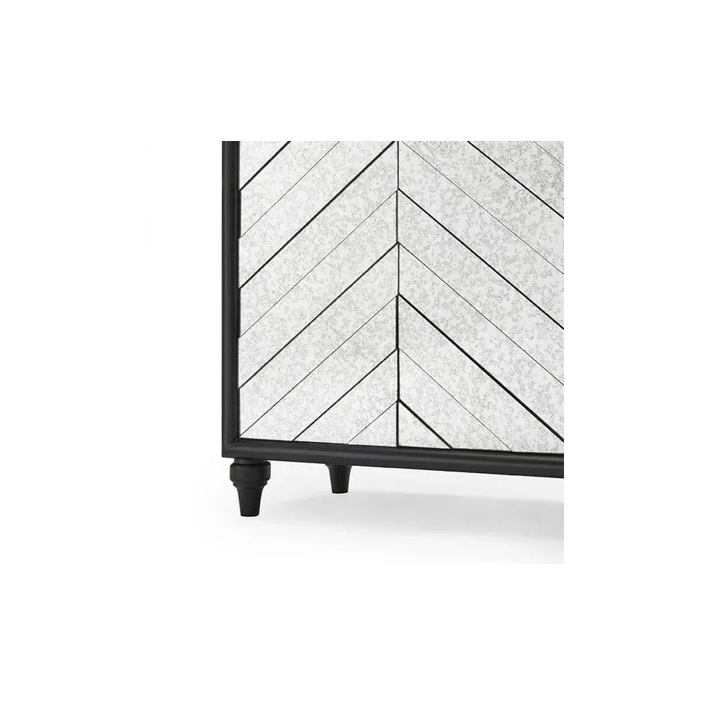 close view of mirrored cabinet door with chevron pattern and black frame on short legs