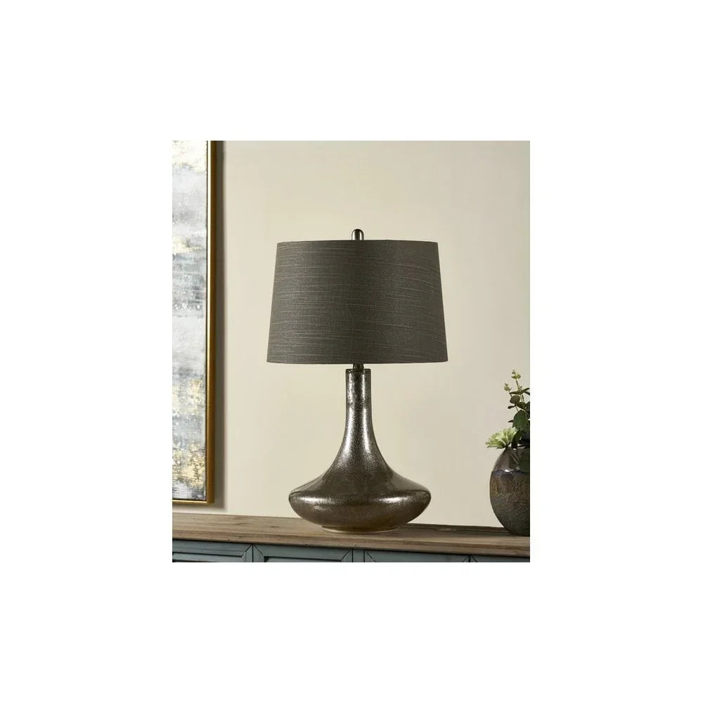 Bronze table lamp with a grey fabric shade on wooden console in modern living room