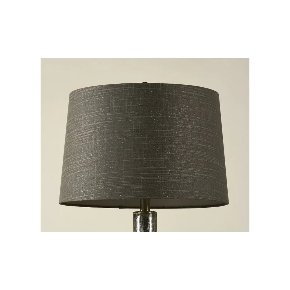 Grey textured lampshade with subtle pattern on a silver lamp base