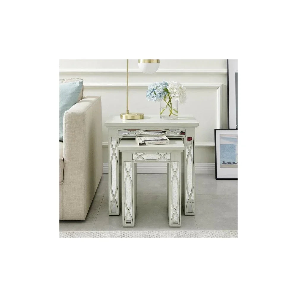 Mirrored nesting tables with geometric accents in living room beside cream sofa