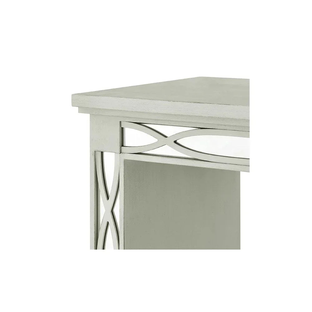 Silver wooden side table corner with decorative mirrored panel and geometric trim detail