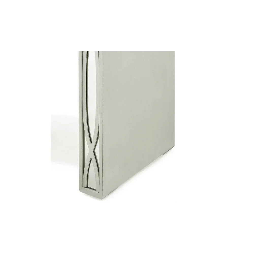 Silver metal table leg with geometric cut-out detailing, close-up view